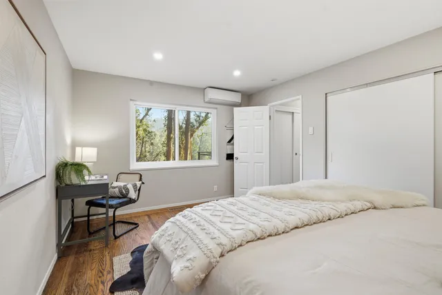 a bedroom with a bed and a window