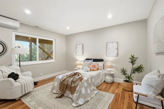 a bedroom with a bed and windows