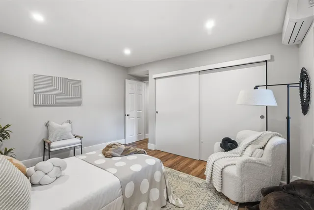 a bedroom with two beds and a couch