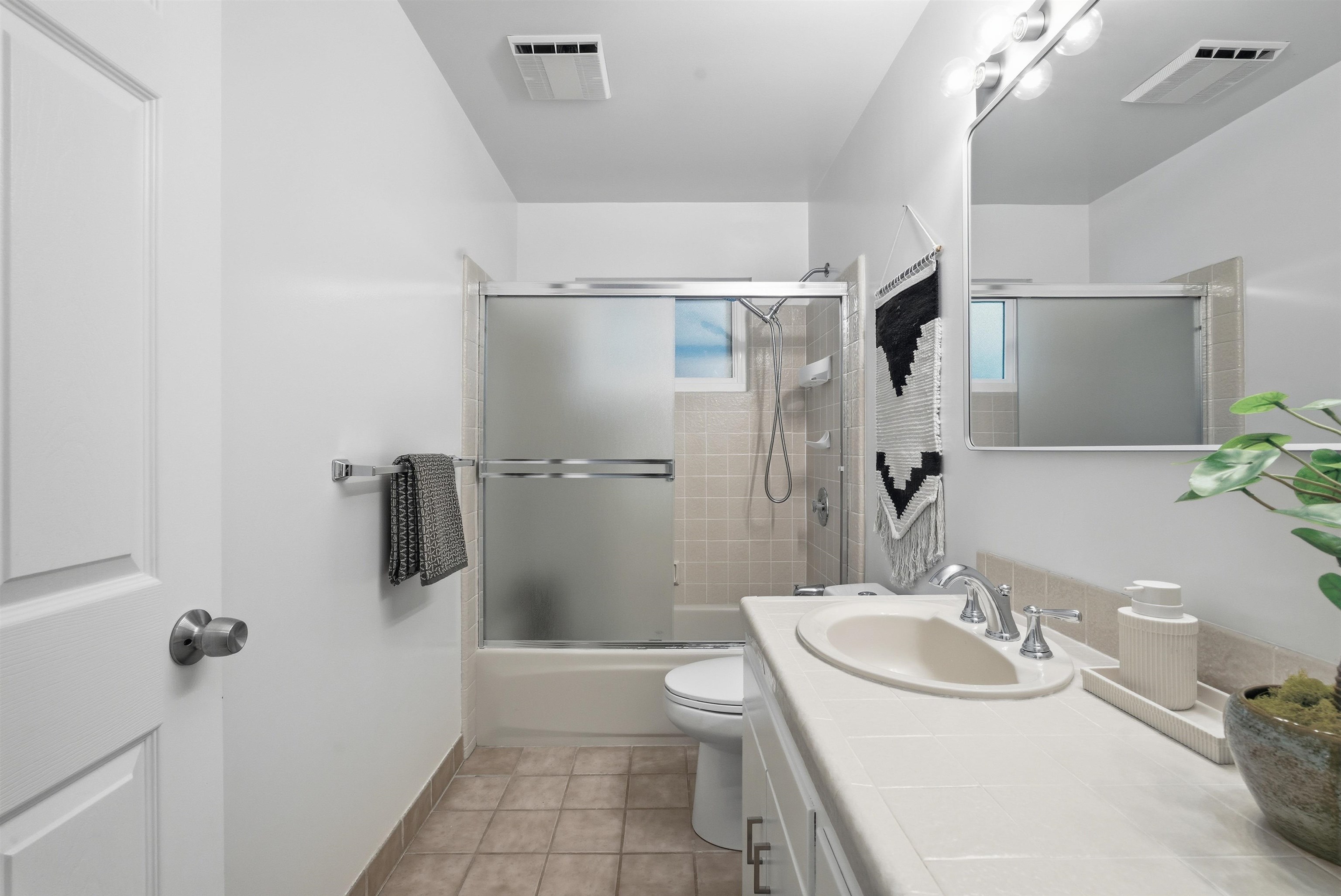 6416 Valley View Road Oakland, CA 94611 - Photo 25 of 58 a bathroom with a sink toilet and shower