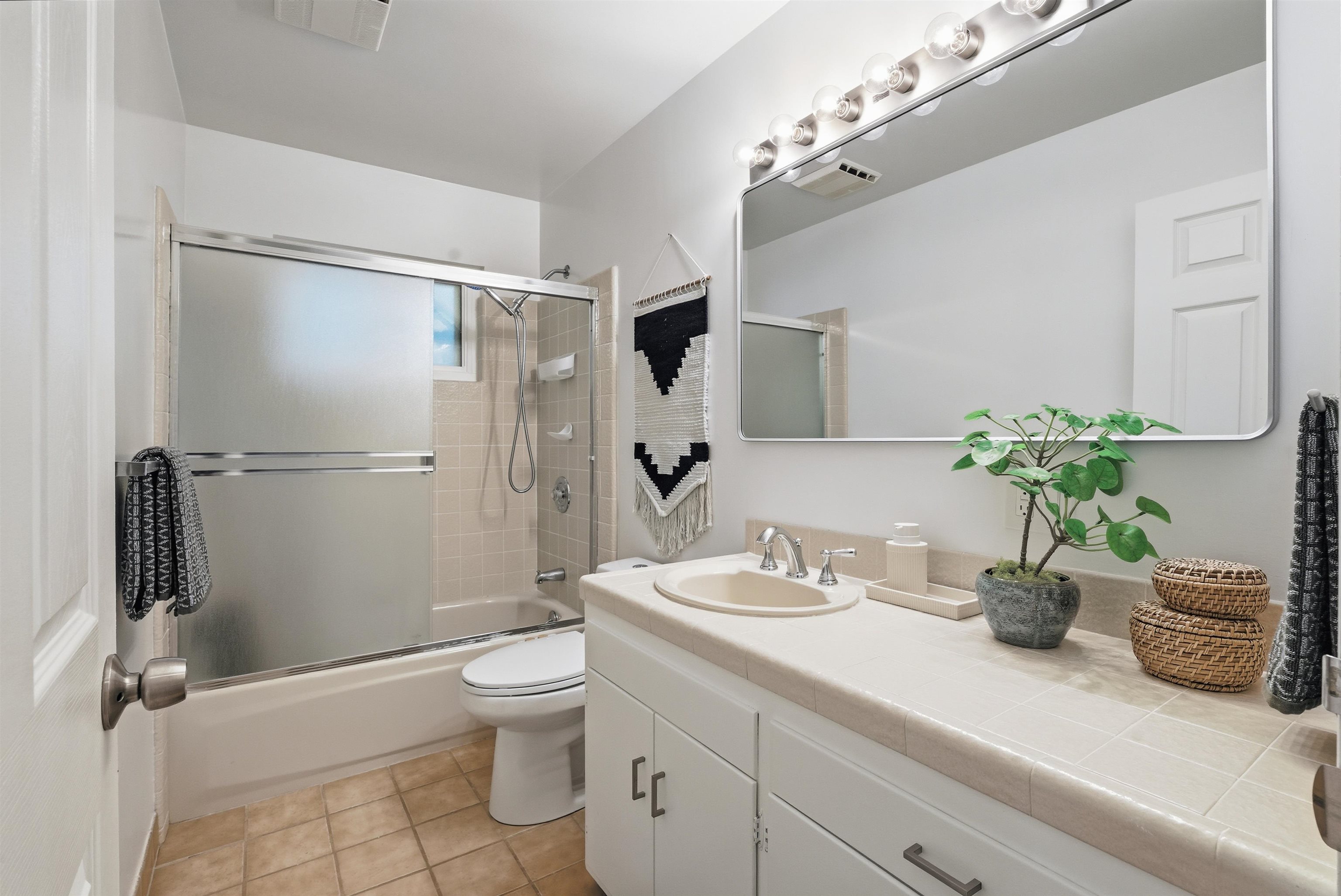 6416 Valley View Road Oakland, CA 94611 - Photo 26 of 58 a bathroom with a granite countertop sink a toilet and shower