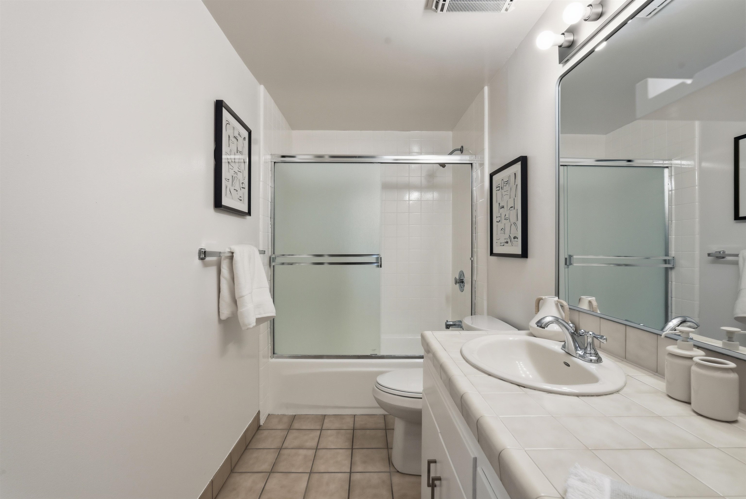 6416 Valley View Road Oakland, CA 94611 - Photo 27 of 58 a bathroom with a sink toilet and shower