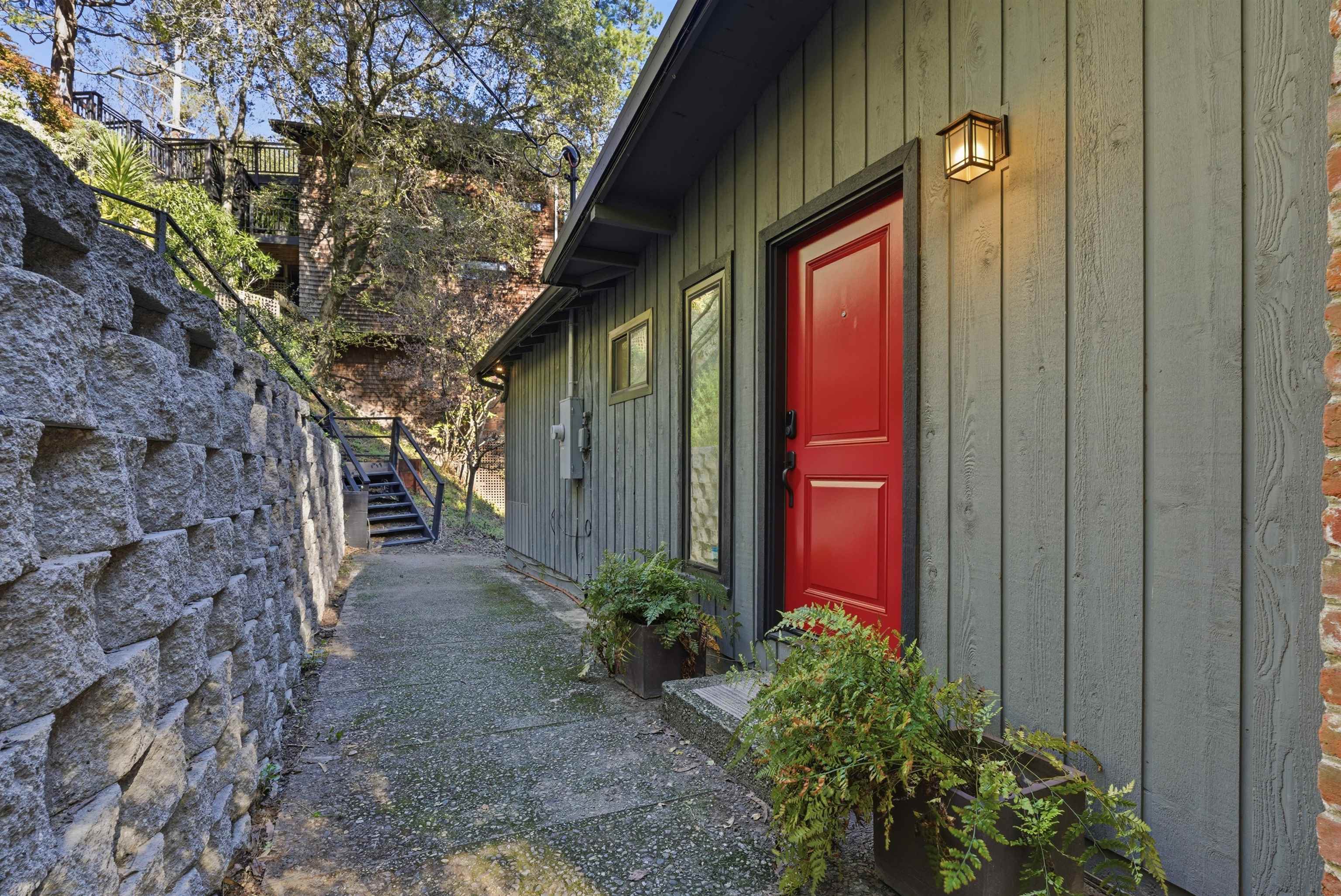 6416 Valley View Road Oakland, CA 94611 - Photo 3 of 58 a view of a brick house with a flower plants next to a road