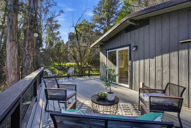 a house view with a sitting space fire pit and outdoor space
