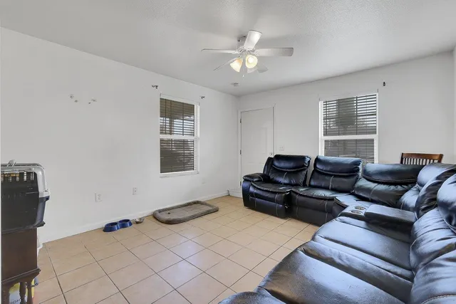 a living room with furniture and kitchen view