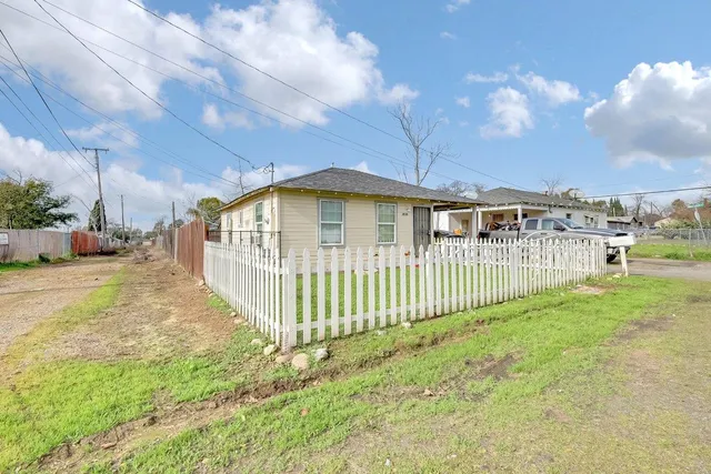 a front view of a house with a garden