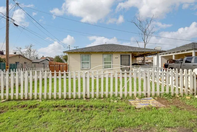 a house view with swimming pool and garden space