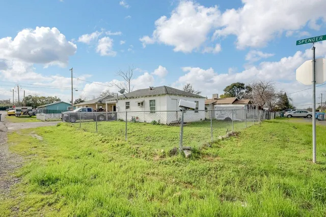 a view of an house with backyard space and balcony