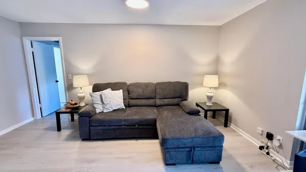 a living room with furniture and a lamp