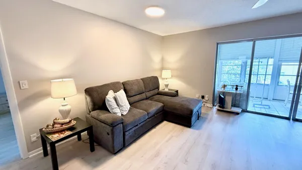 a living room with furniture and wooden floor