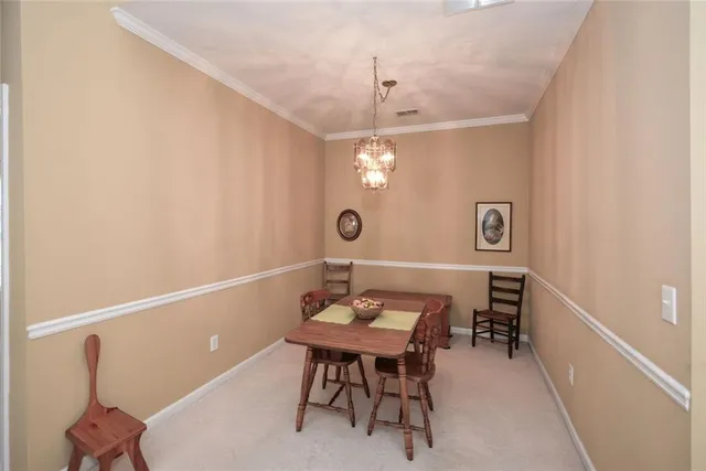 a view of a room that has a table and chairs in it