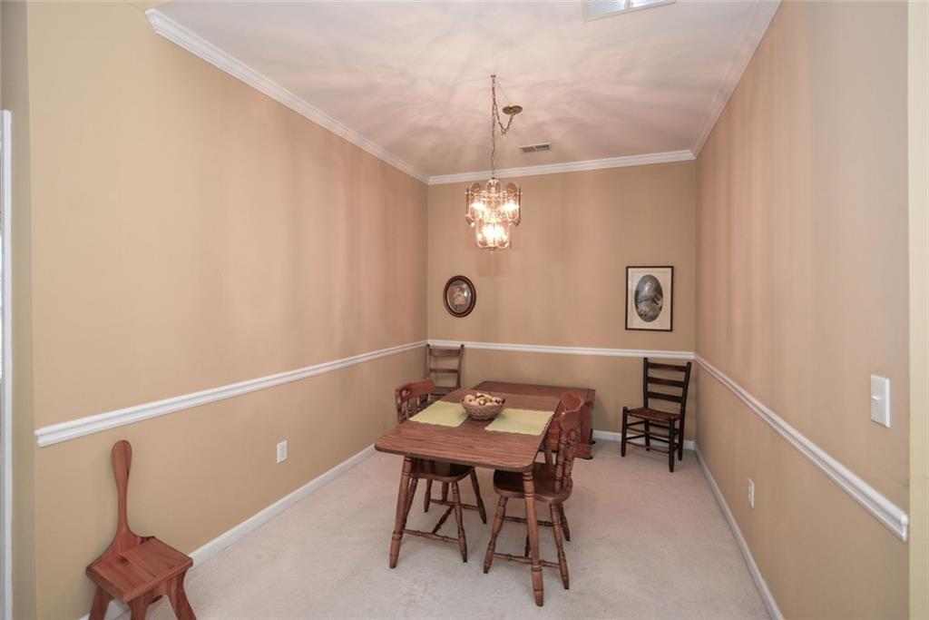 1471 Settlers Walk Way, Unit 5 Marietta, GA 30060 - Photo 11 of 29 a view of a room that has a table and chairs in it
