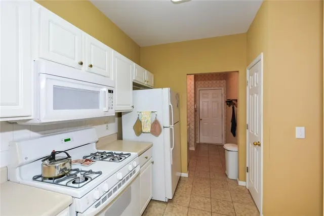 a kitchen with a stove and a refrigerator