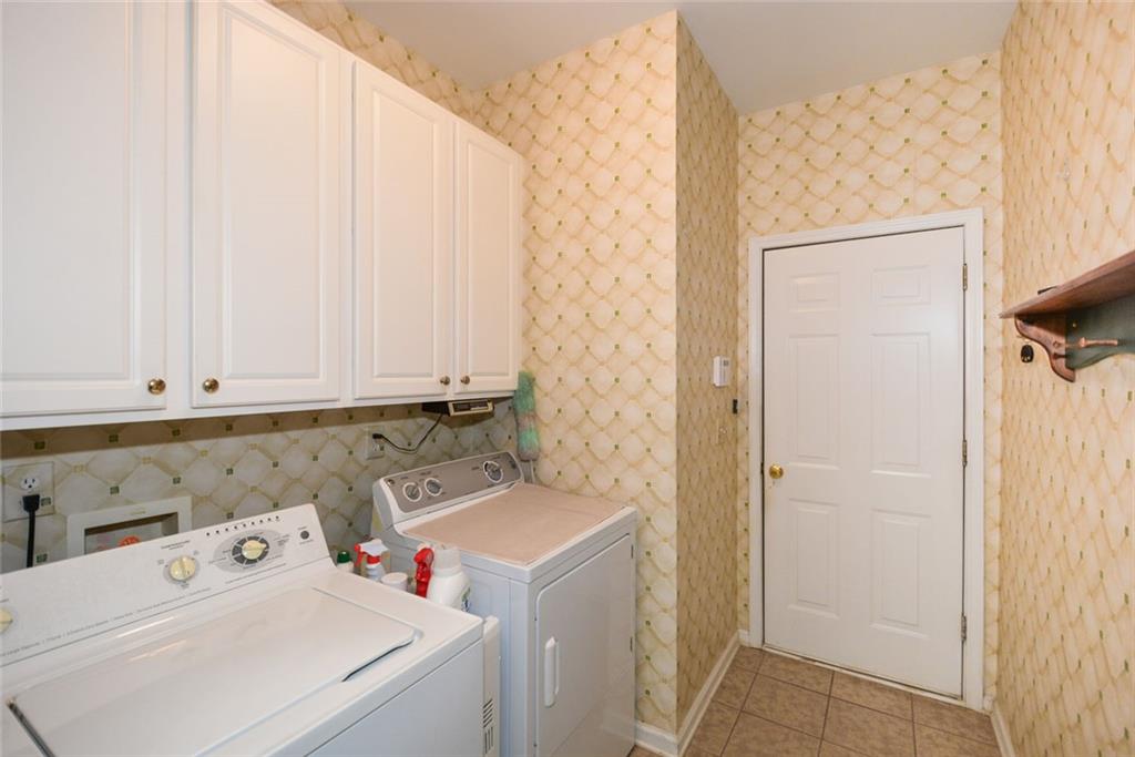 1471 Settlers Walk Way, Unit 5 Marietta, GA 30060 - Photo 17 of 29 a utility room with dryer and washer