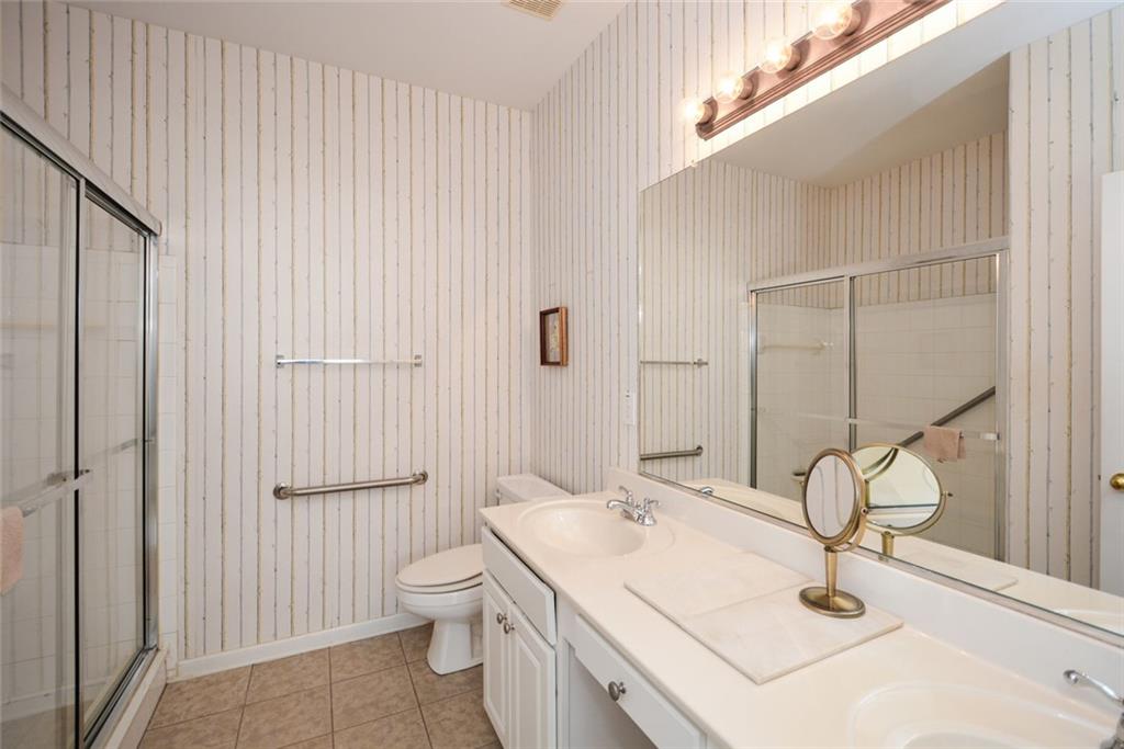 1471 Settlers Walk Way, Unit 5 Marietta, GA 30060 - Photo 23 of 29 a bathroom with a sink a toilet and shower
