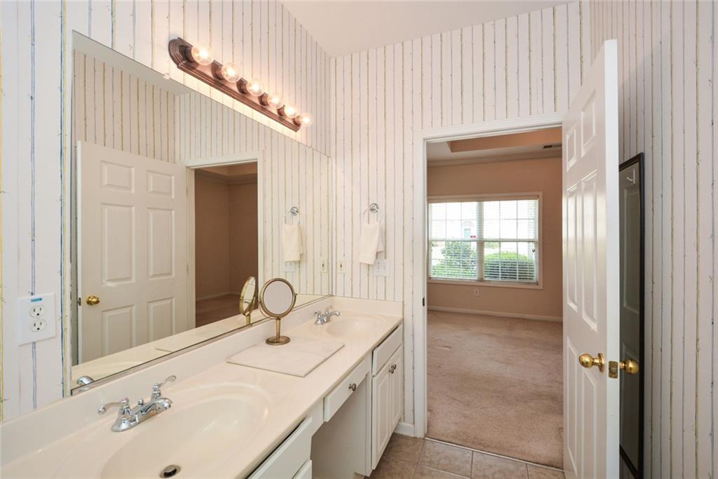 1471 Settlers Walk Way, Unit 5 Marietta, GA 30060 - Photo 24 of 29 a bathroom with a sink and a mirror