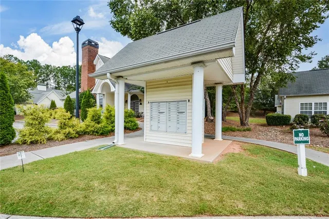a front view of a house with a yard and table and chairs