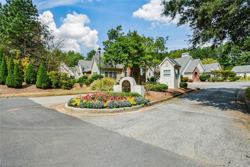 1471 Settlers Walk Way, Unit 5 Marietta, GA 30060 - Photo 29 of 29 a house with lots of trees in the background