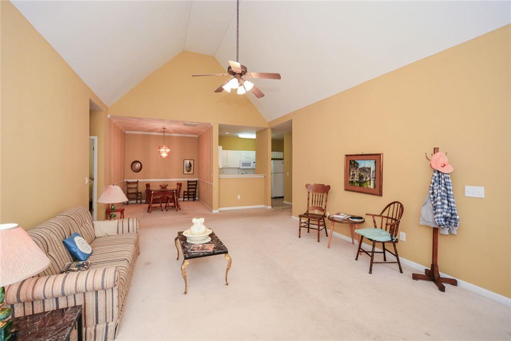 1471 Settlers Walk Way, Unit 5 Marietta, GA 30060 - Photo 6 of 29 a living room with furniture and a chandelier