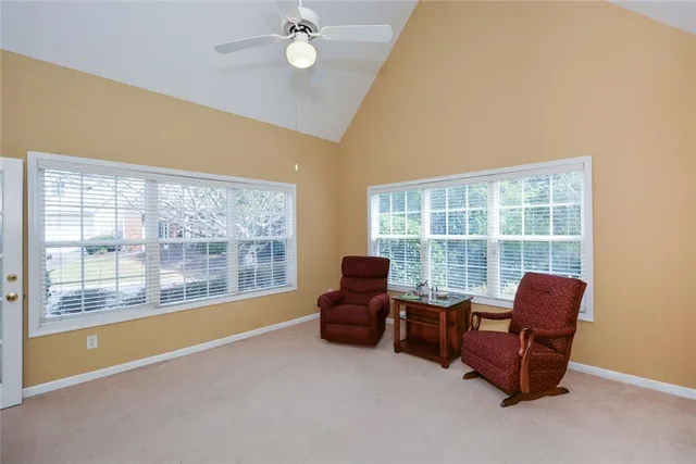a living room with furniture and a floor to ceiling window