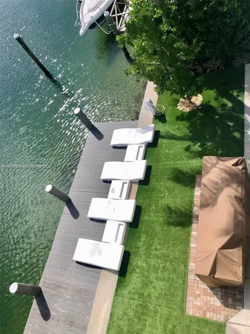 a dining room with furniture and a potted plant