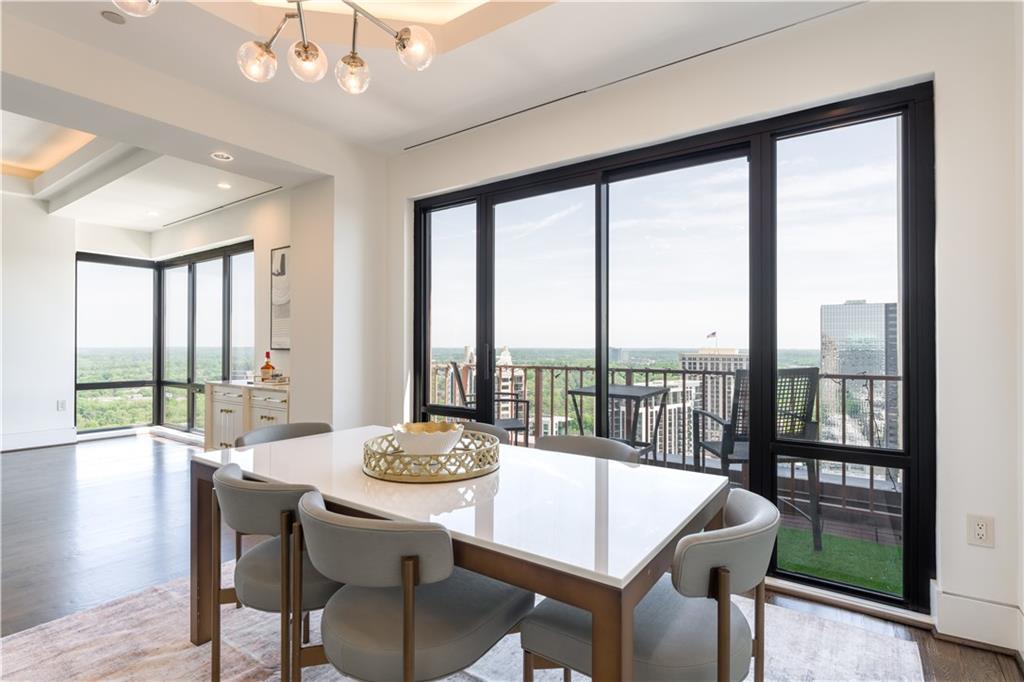 3475 Oak Valley Road Northeast, Unit 2940 Atlanta, GA 30326 - Photo 17 of 26 a view of a dining room with furniture window and wooden floor