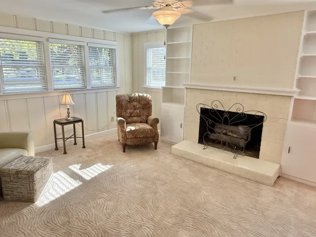 a view of empty room with fireplace and windows