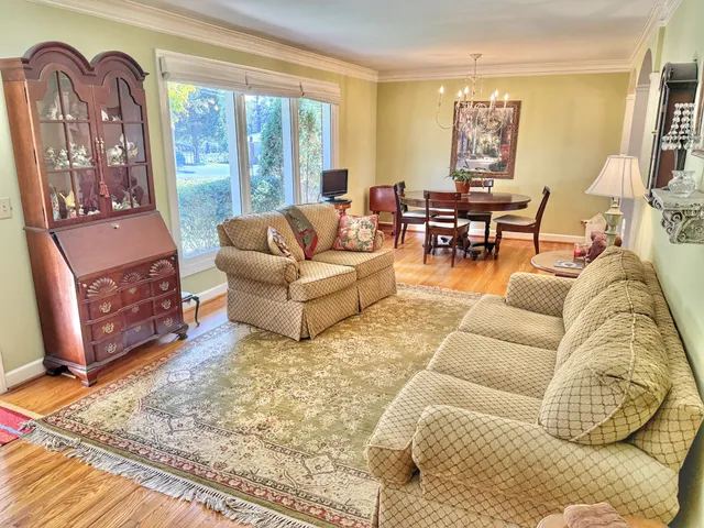 a living room with fireplace furniture and a large window