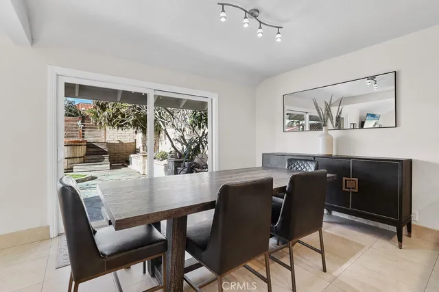 a view of a dining room with furniture large window and wooden floor