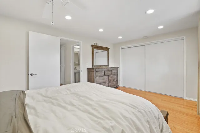 a bedroom with a large bed and a chandelier