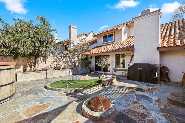 a front view of a house with garden and patio
