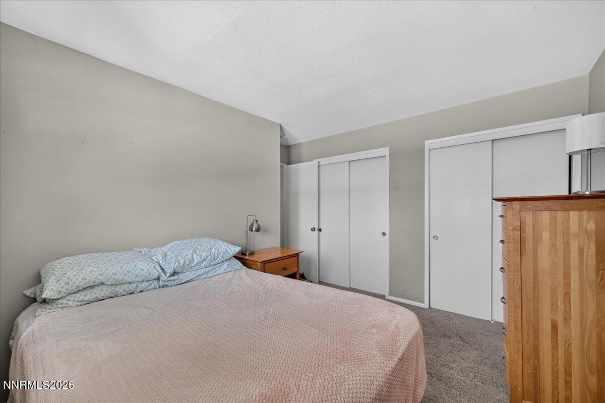 5 Smithridge Park Reno, NV 89502 - Photo 17 of 24 a bedroom with a bed and a refrigerator