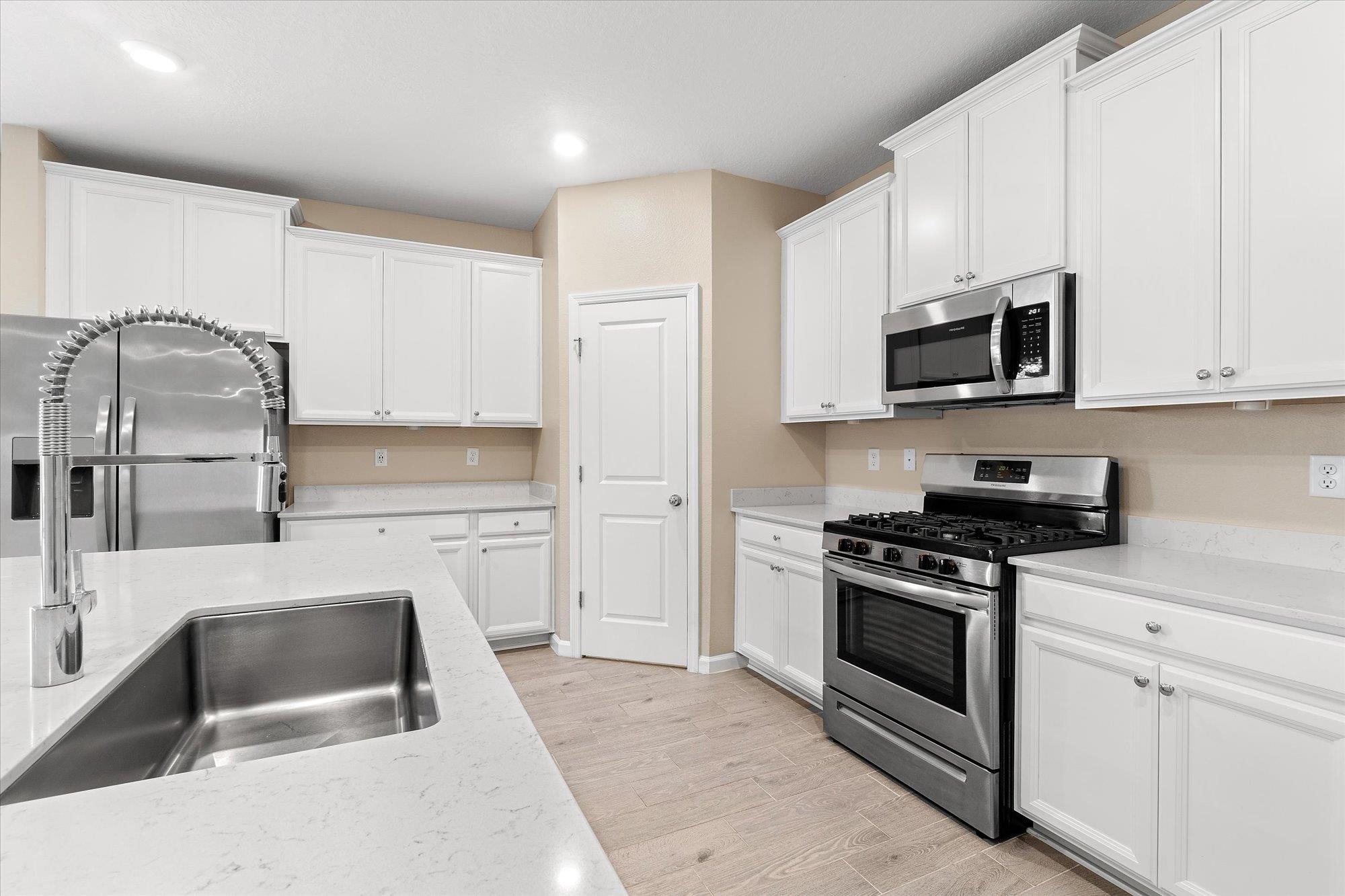 204 Field Flower Way St. Augustine, FL 32092 - Photo 12 of 60 a kitchen with granite countertop a sink a stove and refrigerator