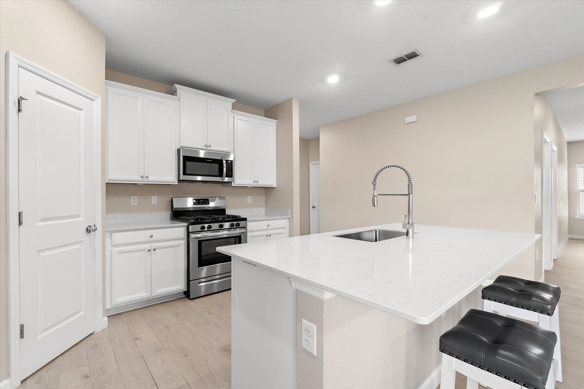 204 Field Flower Way St. Augustine, FL 32092 - Photo 13 of 60 a kitchen with a sink stainless steel appliances and white cabinets