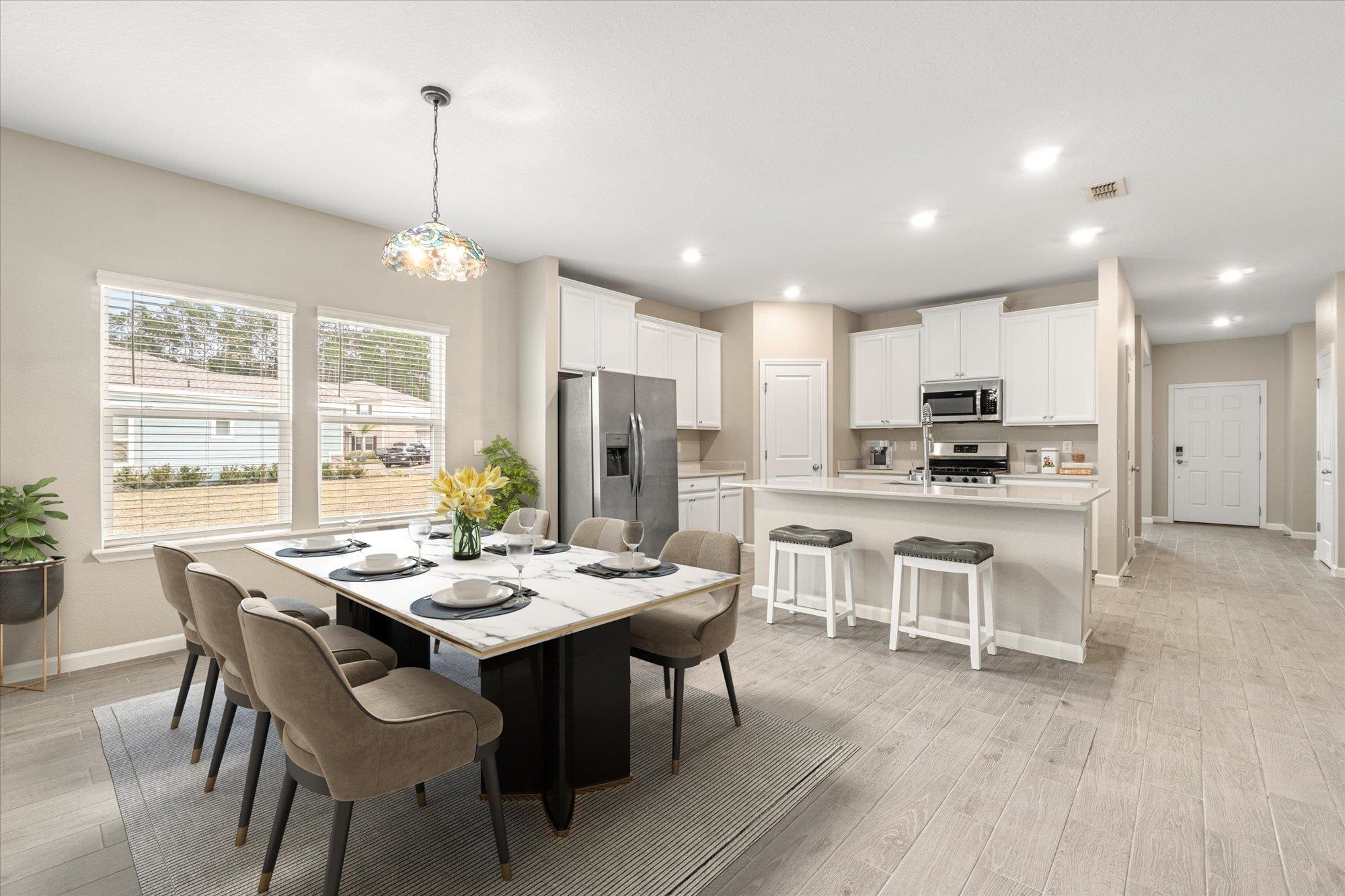 204 Field Flower Way St. Augustine, FL 32092 - Photo 18 of 60 a view of a dining room and livingroom with furniture wooden floor a chandelier