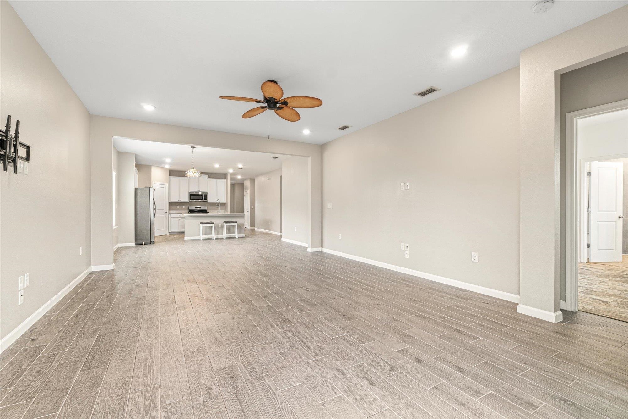 204 Field Flower Way St. Augustine, FL 32092 - Photo 21 of 60 a view of a work space with wooden floor and a ceiling fan