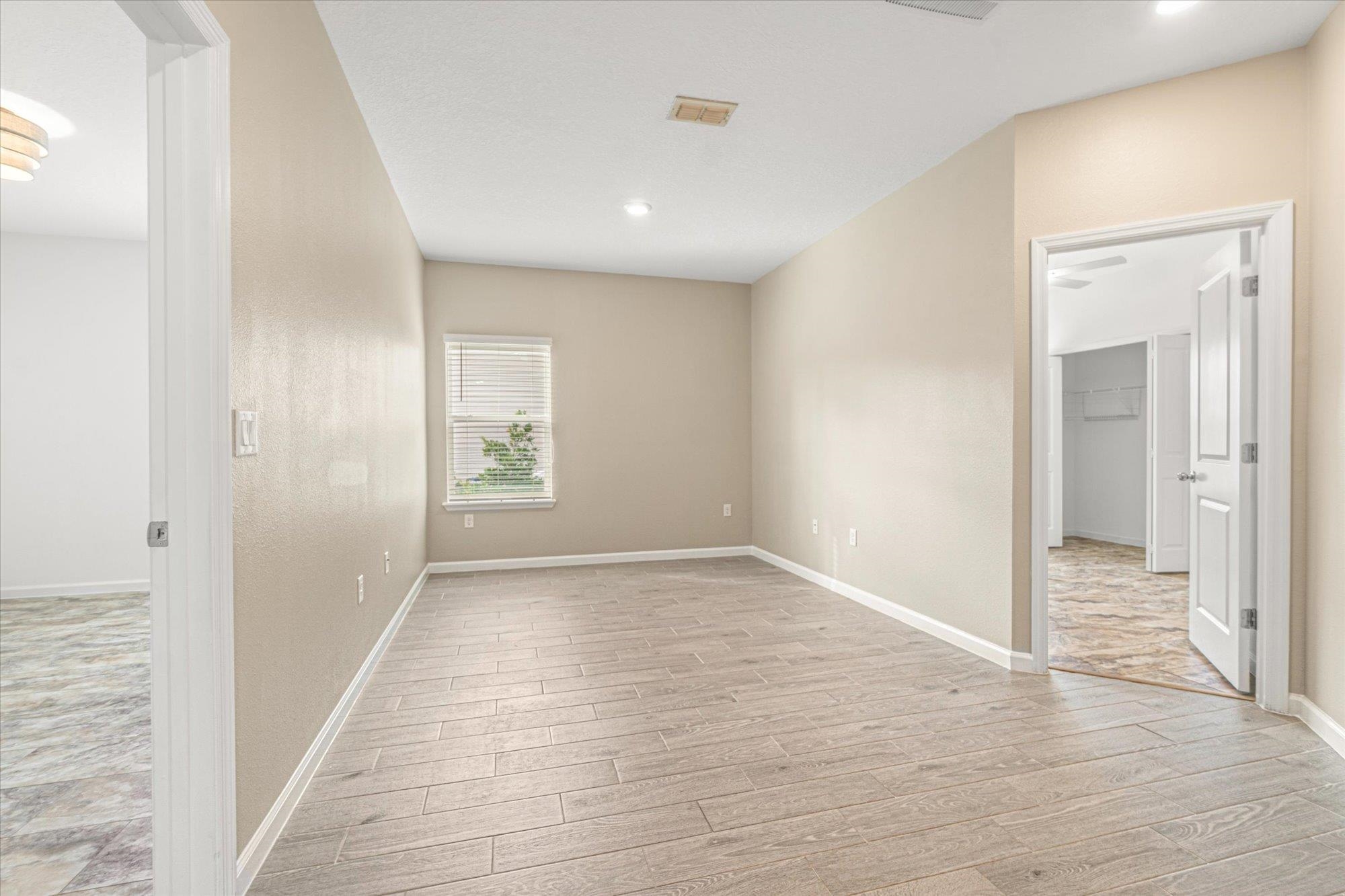 204 Field Flower Way St. Augustine, FL 32092 - Photo 23 of 60 an empty room with wooden floor and windows