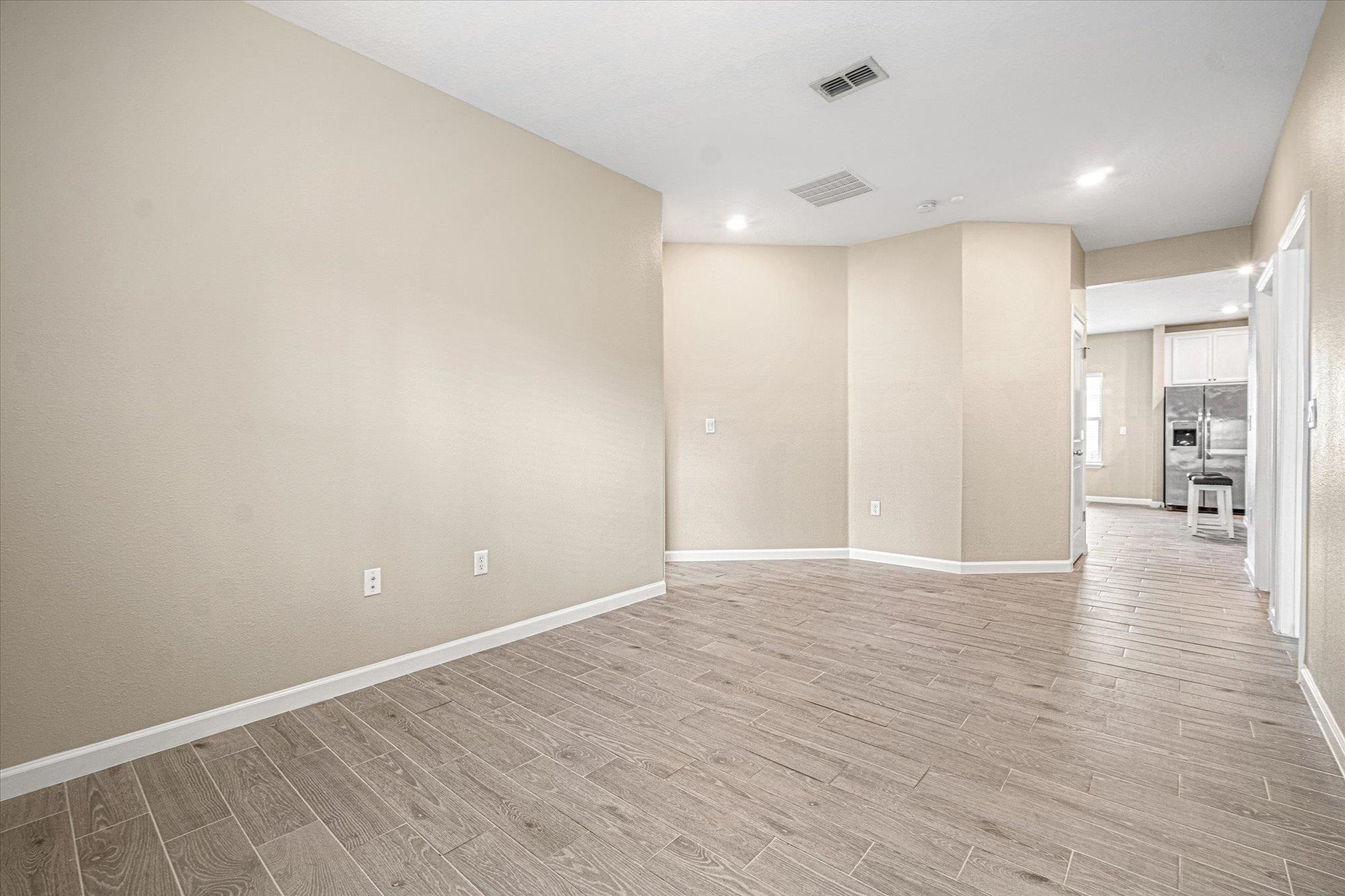 204 Field Flower Way St. Augustine, FL 32092 - Photo 25 of 60 a view of an empty room with wooden floor and a bathroom