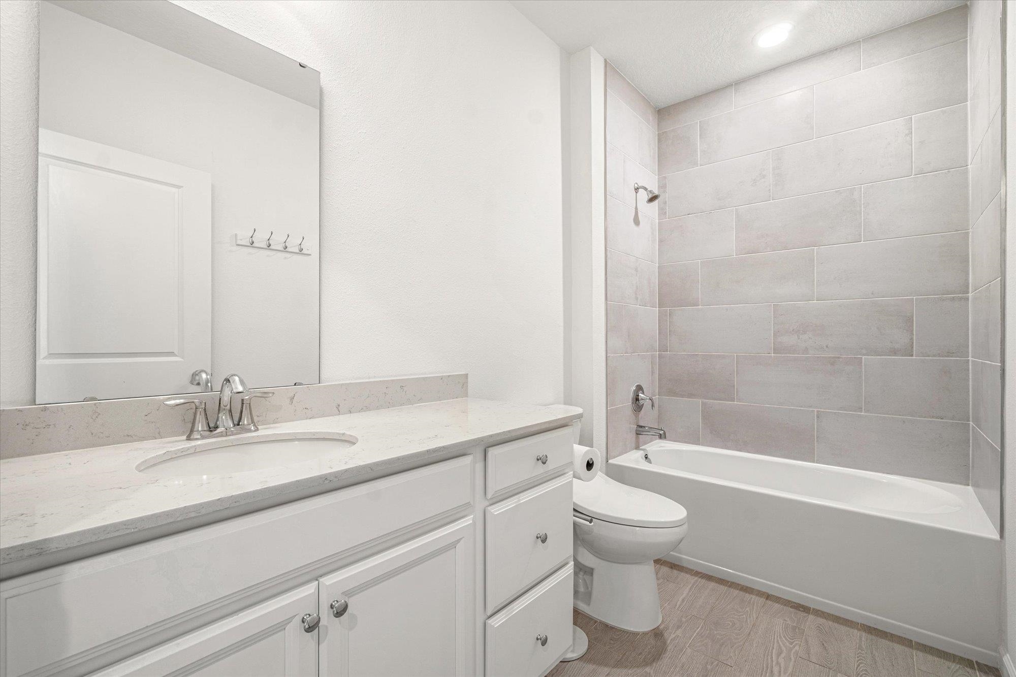 204 Field Flower Way St. Augustine, FL 32092 - Photo 36 of 60 a bathroom with a granite countertop sink a toilet and a bathtub