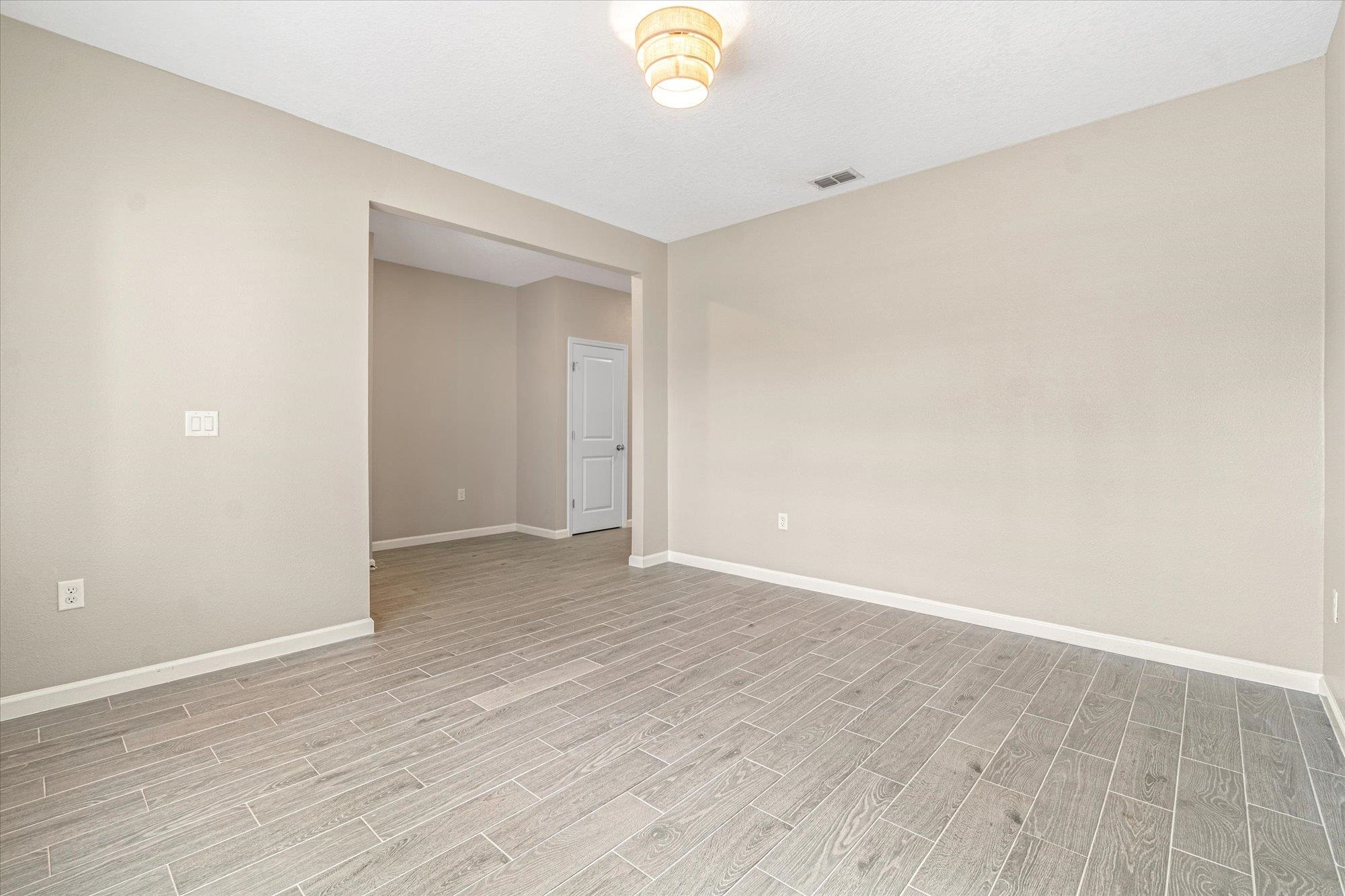 204 Field Flower Way St. Augustine, FL 32092 - Photo 44 of 60 a view of an empty room with wooden floor and a window