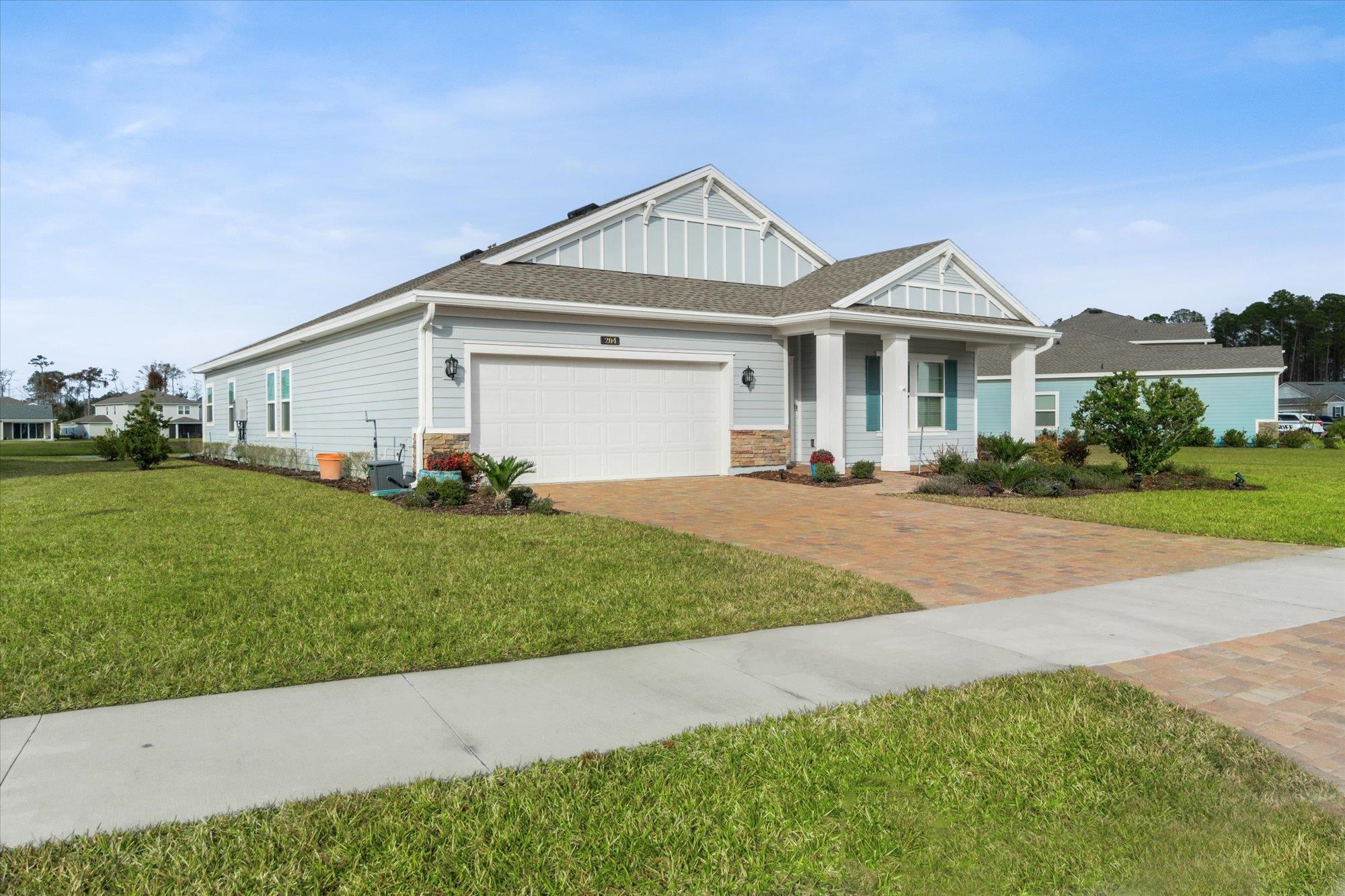 204 Field Flower Way St. Augustine, FL 32092 - Photo 52 of 60 a front view of a house with a yard and garage