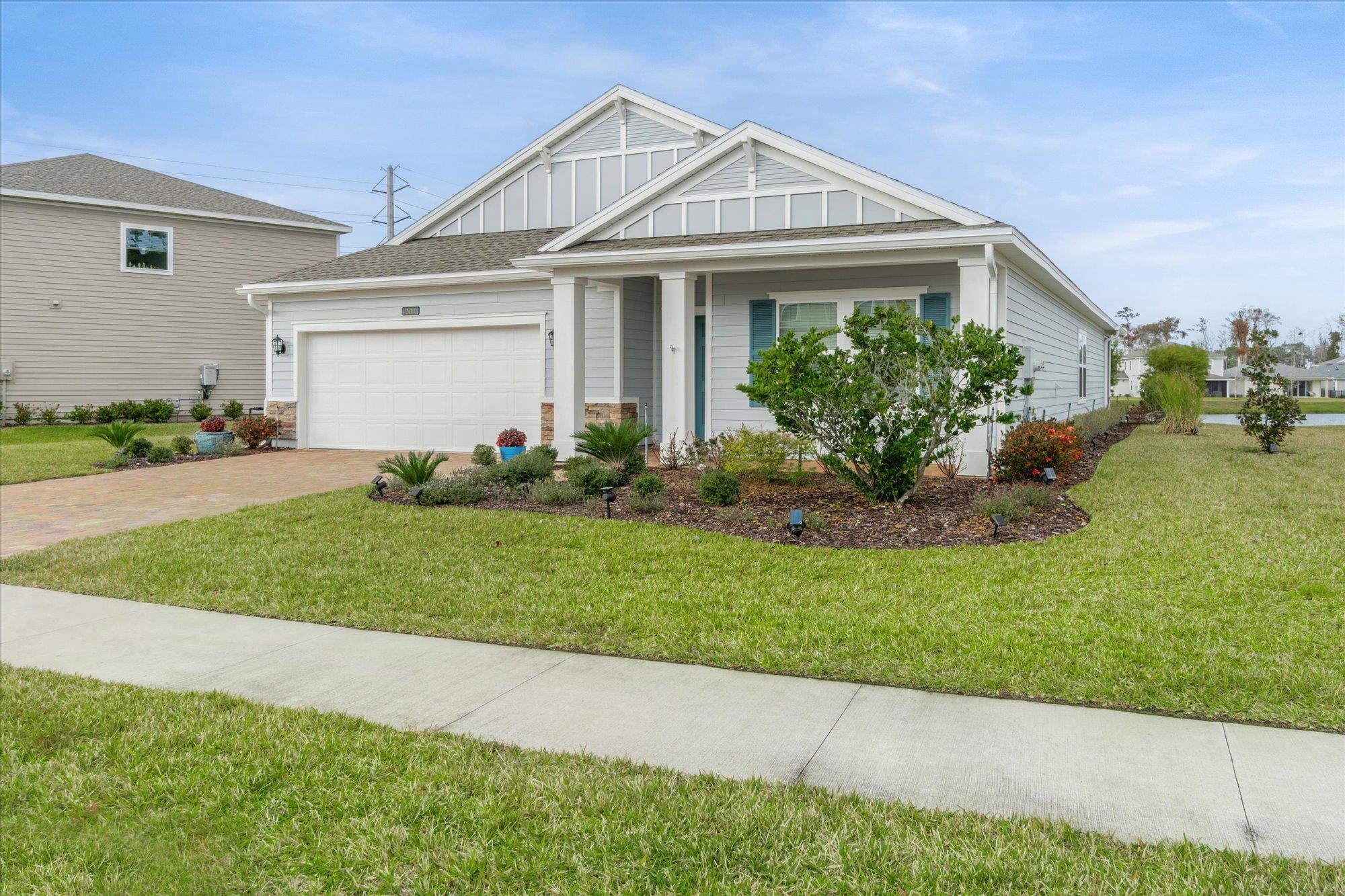 204 Field Flower Way St. Augustine, FL 32092 - Photo 53 of 60 a front view of a house with a garden and yard
