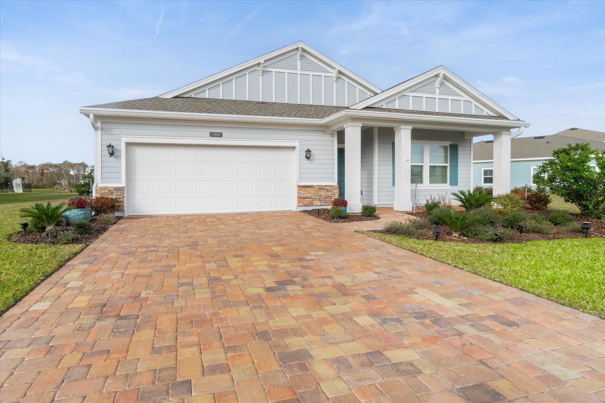 204 Field Flower Way St. Augustine, FL 32092 - Photo 7 of 60 a front view of a house with a yard and garage