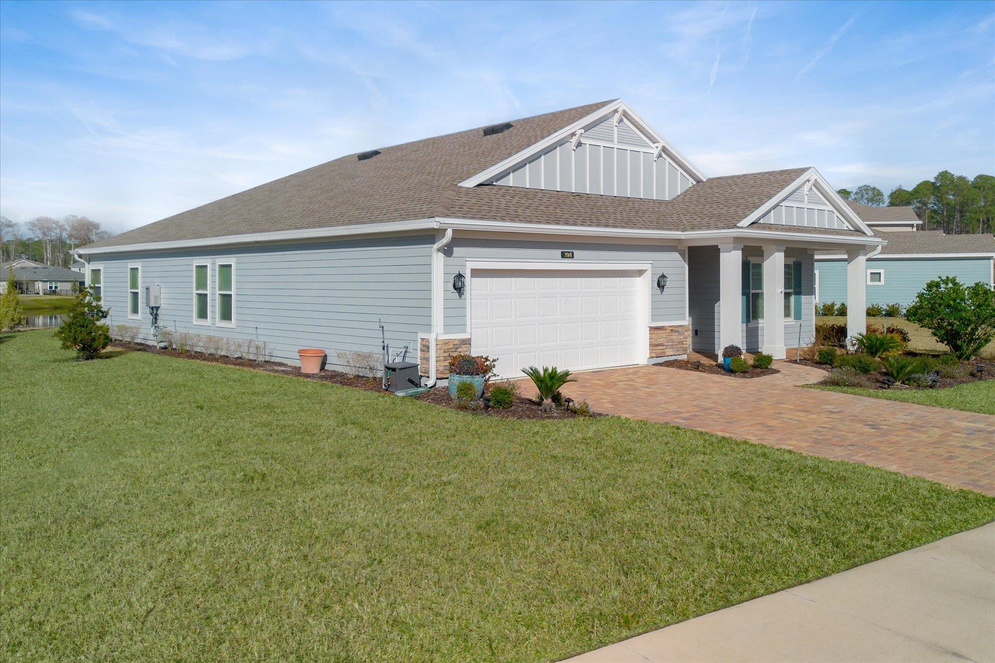 204 Field Flower Way St. Augustine, FL 32092 - Photo 8 of 60 a front view of house with yard and green space