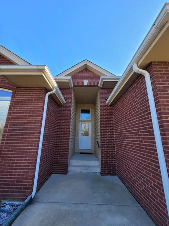 a view of a house with an empty space and garage