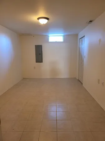 an empty room with projector and bathroom