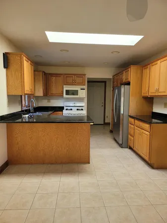 a kitchen with stainless steel appliances a refrigerator sink and cabinets