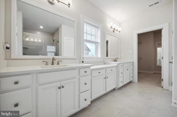 325 Piper Lane Exton, PA 19341 - Photo 19 of 24 a spacious bathroom with double sink and a mirror