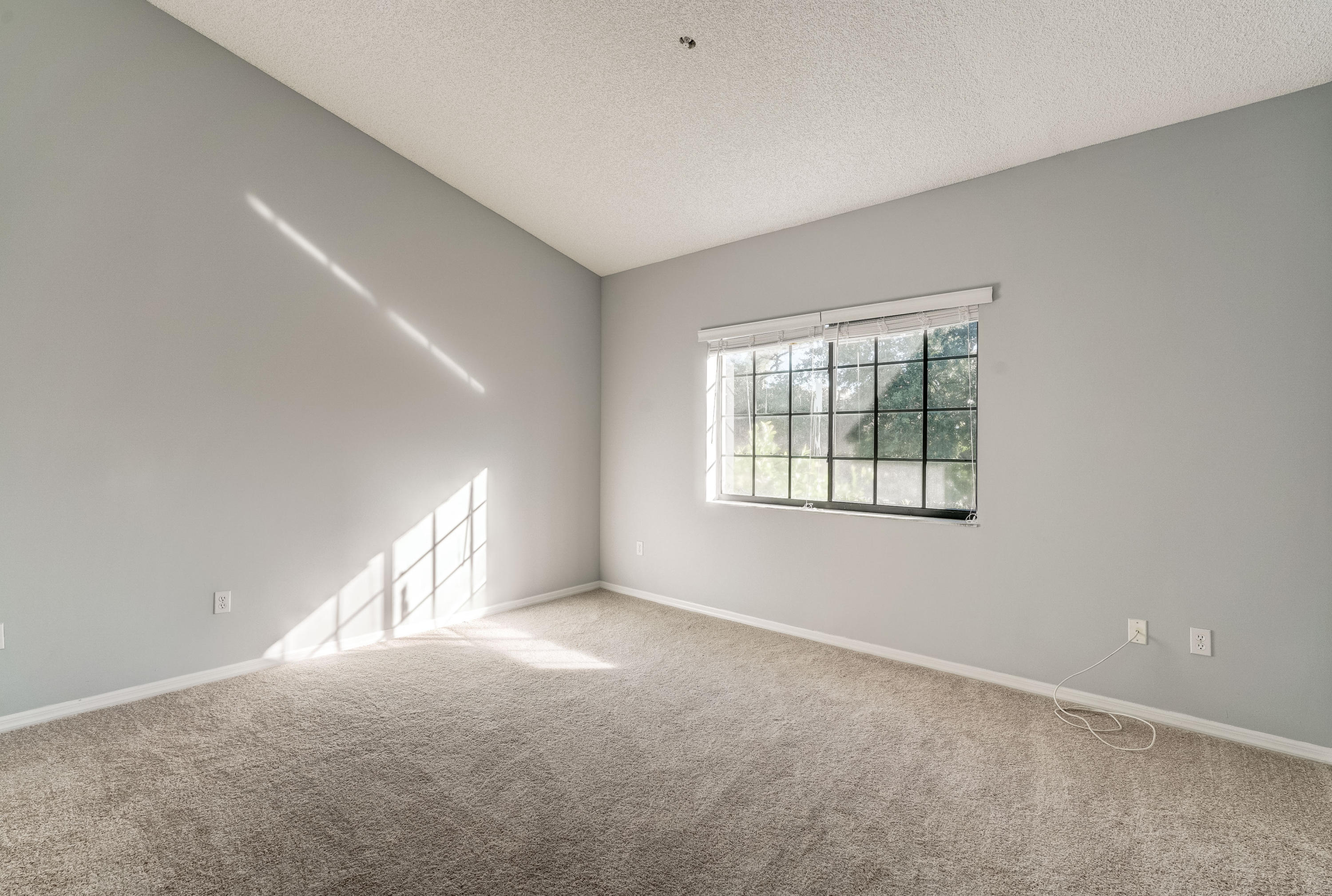 4685 Haverhill Road, Unit C1 West Palm Beach, FL 33417 - Photo 16 of 37 a view of an empty room with a window