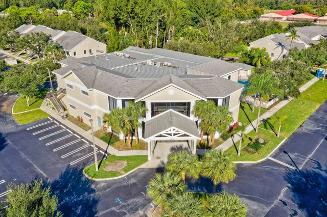 an aerial view of a house with a yard and garden
